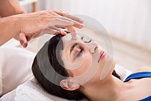 Calm Woman Receiving Reiki Treatment