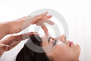 Calm Woman Receiving Reiki Treatment