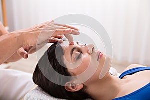 Calm Woman Receiving Reiki Treatment