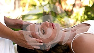 Calm woman receiving reiki treatment