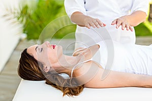 Calm woman receiving reiki treatment