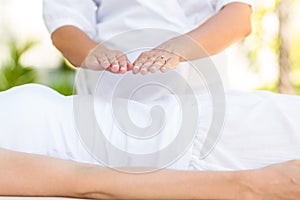 Calm woman receiving reiki treatment