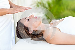 Calm woman receiving reiki treatment