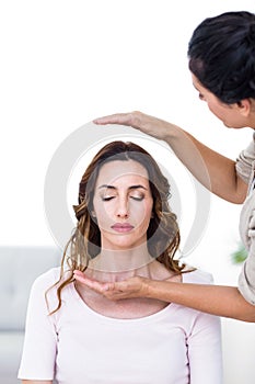 Calm woman receiving reiki treatment