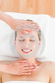 Calm woman receiving reiki treatment