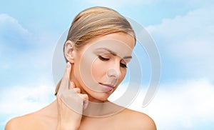 Calm woman touching her ear