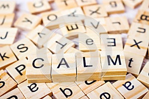 calm Word on Background of cubes with letters. Sign with wooden cubes