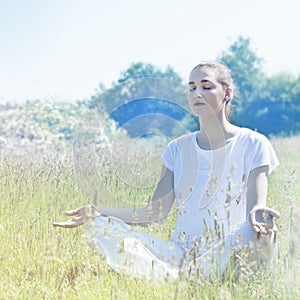 Calm yoga woman wearing soft white in connection to nature