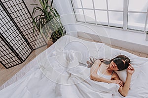 Calm young asian girl sleeping in cozy apartment