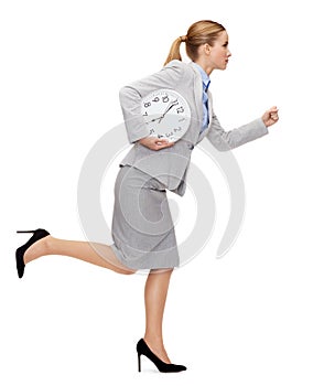 Calm young businesswoman with clock running