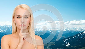Calm young woman with finger on lips