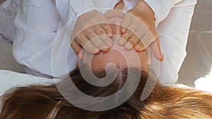 Calm young woman sleeping well in comfortable cozy bed on white soft pillows linen and waking up in the morning,insomnia