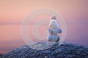 Calming zen rock stack by a lake photo