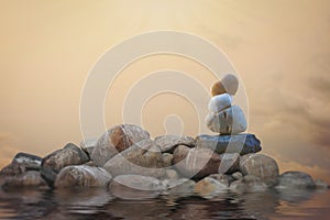 Calming zen rock stack by a lake