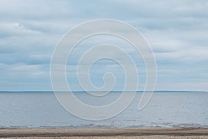 Calmness water and cloud skies above seascape.