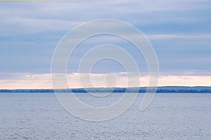 Calmness water and cloud skies above seascape.