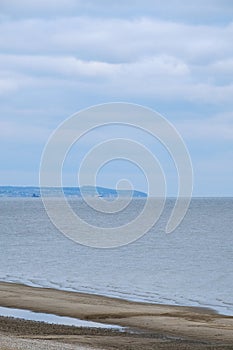 Calmness water and cloud skies above seascape.