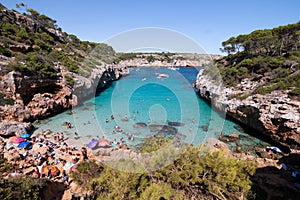 Calo des Moro, Majorca, Spain - August 7, 2020: People enjoying one of the most beautiful coves with turquoise waters in Majorca