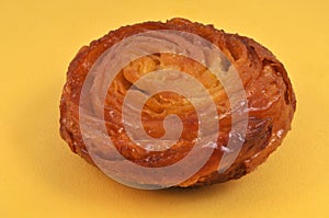 Kouign-amann close-up on a yellow background photo