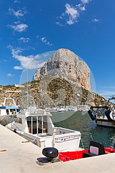 Calp Spain marina with boats and famous rock landmark