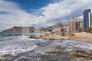 Calp Spain view of beach waves and seafront hotels and apartments photo