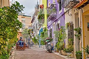 Street in the old town of Calpe with colorful houses and restaurant terraces, Alicante, Spain.