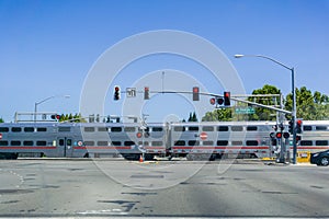 Caltrain crossing at a street junction near a residential neighborhood in Sunnyvale