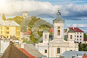 Calvary and Church of the assumption with sun rays in Banska Stiavnica