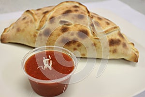 Calzone pizza. Italian food. Calzone pizza photograph on plate.