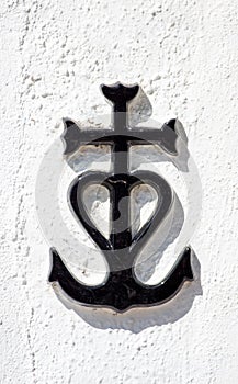 The Camargue Cross on a white wall in a sunny day in France