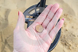 CAMBER SANDS, ENGLAND- 18 September 2021: A found penny whilst metal detecting on Camber Sands beach