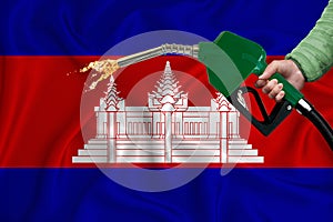 CAMBODIA flag Close-up shot on waving background texture with Fuel pump nozzle in hand. The concept of design solutions. 3d