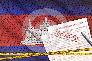 Cambodia flag and Health insurance claim form with covid-19 stamp. Coronavirus or 2019-nCov virus concept