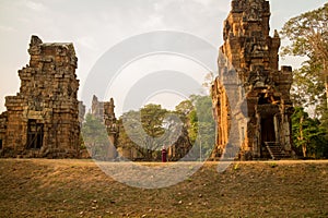 Cambodian Asian Girl by Temple Towers of Angkor Thom