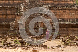 Cambodian Asian Girl in Traditional Dress Sits at Phimeanakas Temple in Angkor Thom