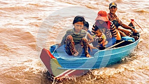 Cambodian family on a boat on Tonle Sap Lake.