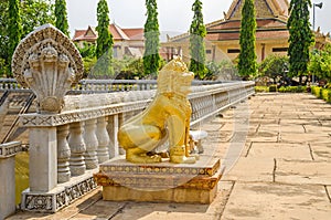 Cambodian five-headed naga and a lion as guardian statues in the