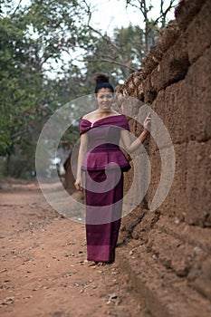 Cambodian Girl in Khmer Dress by the Ancient Wall of Phnom Bakheng, Angkor City