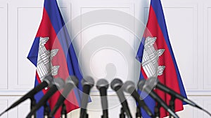 Cambodian official press conference. Flags of Cambodia and microphones. Conceptual 3D animation