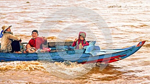 Cambodian people live on Tonle Sap Lake in Siem Reap, Cambodia. Cambodian family on a boat near the fishing village of Tonle Sap L