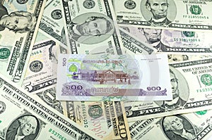 Cambodian Riel (KHR) on many dollars background