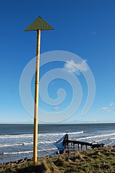 Cambois beach with pipeline and marker post