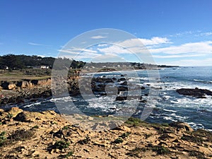 Cambria overview of rocky shoreline against the tide