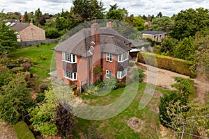 Elevated view of large detached house and garden plot