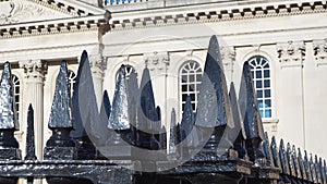 Cambridge, England. The black metal gate with pointed spikes of the Senate House of the University of Cambridge