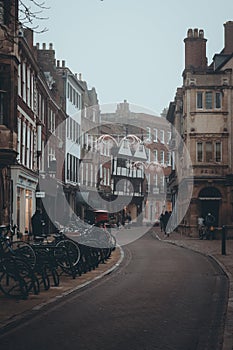 Cambridge UK December 2020 Vertical moody winter shot of Saint John's street in the center of Cambridge city. Bikes parked o