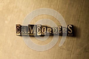 CAMCORDERS - close-up of grungy vintage typeset word on metal backdrop