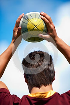 We came to win. Rearview shot of a rugby player taking a lineout.