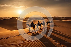 Camel caravan goes through the desert at sunset