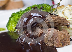 Camel steak in chocolate sauce a la carte photo